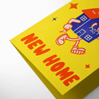 Yellow box with cartoon house and 'New Home' text on a white background