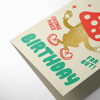 Birthday card with colorful text and graphics on a beige background