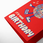 Red birthday card with cartoon character and 'It's Your Birthday' text on a white background