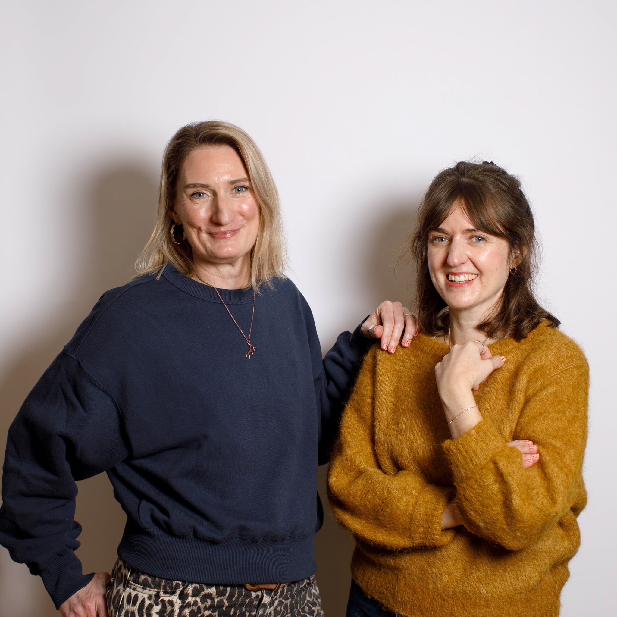 Two women standing close together against a plain background. Founders of the brand two~good