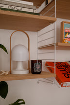 Future Focused woody scented candle styled on a home shelf