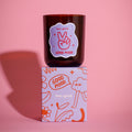 Candle with 'Good Mood' label on a matching box against a pink background bold linear illustrations fruity scent