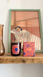 Glow Slow autumn scented candle burning in a cosy home
