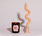 Candle with a wiggle candlestick on a plain background soy wax candle grounding earthy scent